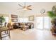 Bright living room featuring tile flooring, a ceiling fan, and sliding door access to patio at 252 Julliard Blvd, Davenport, FL 33897