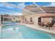 Inviting backyard pool area featuring lounge chairs, an umbrella-covered dining table, and a well-maintained pool at 252 Julliard Blvd, Davenport, FL 33897