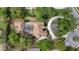 Aerial view of a large home featuring a screened-in pool, mature landscaping, and a circular driveway at 257 New Gate Loop, Lake Mary, FL 32746