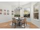 Cozy breakfast nook with a round table, four chairs, and natural light from surrounding windows at 257 New Gate Loop, Lake Mary, FL 32746