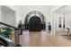 Bright foyer with hardwood floors and a large arched doorway leading to the front entrance at 257 New Gate Loop, Lake Mary, FL 32746