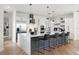 Stylish kitchen featuring a waterfall island, stainless steel appliances, and modern bar stool seating at 257 New Gate Loop, Lake Mary, FL 32746