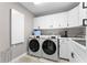 The laundry room features a washer, dryer, upper cabinets, and plenty of counter space at 257 New Gate Loop, Lake Mary, FL 32746