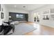 Contemporary living area with a gray accent wall, modern furniture, and natural light from french doors at 257 New Gate Loop, Lake Mary, FL 32746