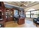 Home office with custom built-ins, a large desk, and natural light from a window at 257 New Gate Loop, Lake Mary, FL 32746