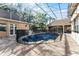 Enclosed pool area with a security fence, surrounded by a stone patio and lush landscaping at 257 New Gate Loop, Lake Mary, FL 32746