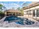 A sparkling pool with a safety fence and surrounding patio, perfect for outdoor relaxation and entertainment at 257 New Gate Loop, Lake Mary, FL 32746