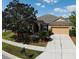 Aerial view of a one-story home with manicured lawn, mulch beds, and a two-car garage at 2705 Treymore Dr, Orlando, FL 32825