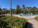 Community pool with brick surround and palm trees offering a relaxing, tropical ambiance at 2705 Treymore Dr, Orlando, FL 32825