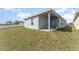 Home exterior features a covered patio in the backyard for outdoor entertaining and relaxation at 2956 Whispering Trails Dr, Winter Haven, FL 33884