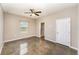 Spacious bedroom with polished concrete floors and ceiling fan, next to a shower and door at 2956 Whispering Trails Dr, Winter Haven, FL 33884