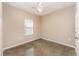 Bright bedroom with neutral walls, polished concrete floors, a window, and ceiling fan at 2956 Whispering Trails Dr, Winter Haven, FL 33884