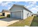 Exterior view showing a two-car garage offering convenience and ample parking at 2956 Whispering Trails Dr, Winter Haven, FL 33884