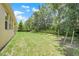 Large backyard with a well-maintained lawn and a view of the surrounding trees at 3036 Country Side Dr, Apopka, FL 32712