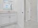 Bright bathroom features a white vanity with a large mirror, adjacent to a white door at 3036 Country Side Dr, Apopka, FL 32712