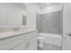 Well-lit bathroom with white vanity, bathtub, shower combination and a tile floor at 3036 Country Side Dr, Apopka, FL 32712