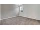 Bedroom featuring a carpeted floor, a large window with blinds and a decorative accent wall at 3036 Country Side Dr, Apopka, FL 32712