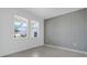 Bright bedroom featuring neutral tones, a large window with blinds, and modern tile flooring at 3036 Country Side Dr, Apopka, FL 32712