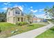 Two-story home with a well-manicured lawn, complemented by a brick driveway and sidewalk at 3036 Country Side Dr, Apopka, FL 32712