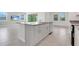 Bright kitchen features gray countertops, stainless steel appliances, and white cabinets at 3036 Country Side Dr, Apopka, FL 32712