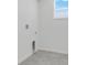 Bright laundry room with tile floor, window with blinds and utility connections in a neutral color at 3036 Country Side Dr, Apopka, FL 32712