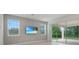 Contemporary living area with a TV, sliding glass doors to the patio, and ample natural light at 3036 Country Side Dr, Apopka, FL 32712