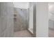 Modern bathroom featuring a tiled walk-in shower with built-in shelves and a glass enclosure at 3036 Country Side Dr, Apopka, FL 32712