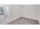 Spacious walk-in closet with carpeted floor and wire shelving, with view to the main bedroom at 3036 Country Side Dr, Apopka, FL 32712