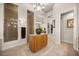 Well-lit bathroom with a granite island counter, walk-in shower, and access to vanities and walk-in closet at 401 Timberwalk Ln, Lake Mary, FL 32746