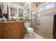 Bright bathroom with shower, granite counter top, tiled floor, and wooden cabinet at 401 Timberwalk Ln, Lake Mary, FL 32746