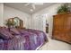 Comfortable bedroom features ceiling fan, wood dresser and ensuite bathroom entrance at 401 Timberwalk Ln, Lake Mary, FL 32746