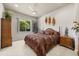 Cozy bedroom with ceiling fan, window view, and wooden furniture at 401 Timberwalk Ln, Lake Mary, FL 32746