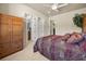 Bedroom features ensuite bathroom, ceiling fan, and a wooden dresser at 401 Timberwalk Ln, Lake Mary, FL 32746