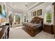 Spacious bedroom with decorative tray ceiling, a window nook, and large windows providing ample natural light at 401 Timberwalk Ln, Lake Mary, FL 32746