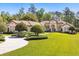 Lush landscaping surrounds this one-story home with a circular driveway and manicured lawn at 401 Timberwalk Ln, Lake Mary, FL 32746