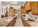 Modern kitchen showcasing wood cabinets and a large granite countertop island with a sink at 401 Timberwalk Ln, Lake Mary, FL 32746