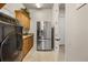 Laundry room with stainless steel refrigerator, cabinetry, and a laundry sink at 401 Timberwalk Ln, Lake Mary, FL 32746