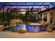 Enclosed pool featuring rock waterfall, lush plants, and relaxing atmosphere at 401 Timberwalk Ln, Lake Mary, FL 32746