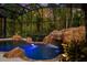 Enclosed pool with waterfall feature, and lush landscaping create a tranquil oasis at 401 Timberwalk Ln, Lake Mary, FL 32746