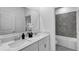 Modern bathroom with double sinks, quartz countertop, and tiled shower with soaking tub at 4113 Jespersen St, Apopka, FL 32712