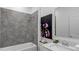 Bathroom showcasing tiled shower over tub, quartz countertop vanity, modern fixtures, and a decorative floral print at 4113 Jespersen St, Apopka, FL 32712