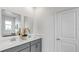 Modern bathroom with double vanity, sleek gray cabinets, white countertop, and dual mirrors at 4120 Jespersen St, Apopka, FL 32712