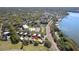 Aerial perspective showing the serene location of the lakefront homes within a lush green neighborhood at 601 W Old Us Highway 441 # 3-A, Mount Dora, FL 32757