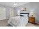 Bedroom featuring white bedding, two bedside tables, and a ceiling fan at 601 W Old Us Highway 441 # 3-A, Mount Dora, FL 32757