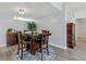 Cozy dining area featuring a wooden table set on a blue patterned rug and dark wood furnishings at 601 W Old Us Highway 441 # 3-A, Mount Dora, FL 32757