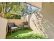 Cozy outdoor patio featuring two wicker chairs, a small table, and faux grass turf at 601 W Old Us Highway 441 # 3-A, Mount Dora, FL 32757