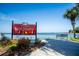 Welcome to Port of Mount Dora sign, with waterfront view and bench seating nearby at 601 W Old Us Highway 441 # 3-A, Mount Dora, FL 32757