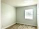 Well-lit bedroom with wood-look flooring and a large window at 6667 Blanton Ct, Orlando, FL 32809