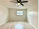 Spacious bedroom with ceiling fan, wood-look flooring, and ample natural light at 6667 Blanton Ct, Orlando, FL 32809