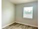 Bright bedroom with wood-look flooring and natural light from the window at 6667 Blanton Ct, Orlando, FL 32809